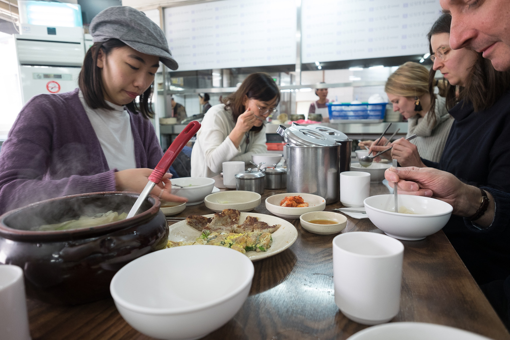 Eating Su Jeoi Bi, a torn-noodle soup.