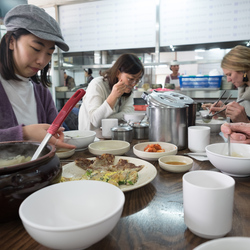 Eating Su Jeoi Bi, a torn-noodle soup.