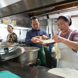 Making Su Jeoi Bi, a torn-noodle soup.