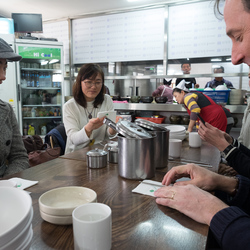 Eating Su Jeoi Bi, a torn-noodle soup.