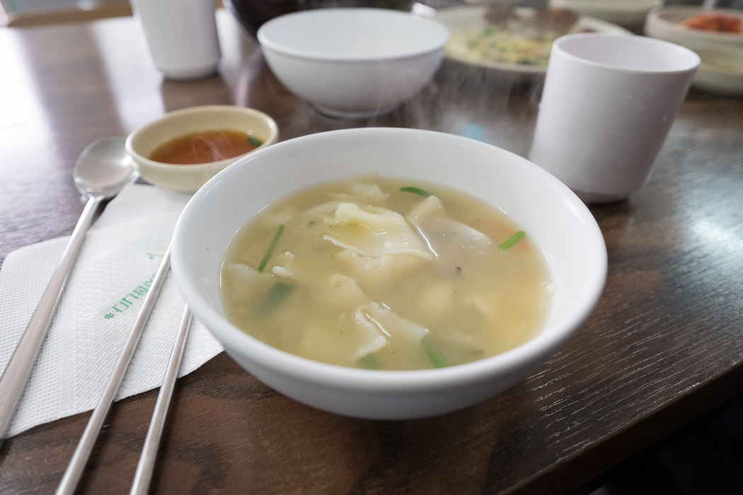 Eating Su Jeoi Bi, a torn-noodle soup.