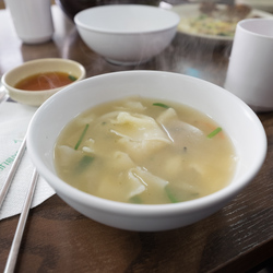 Eating Su Jeoi Bi, a torn-noodle soup.