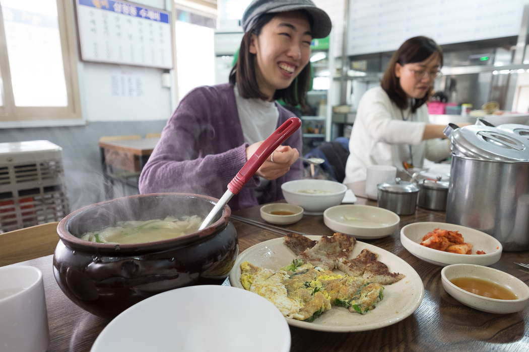 Eating Su Jeoi Bi, a torn-noodle soup.