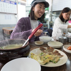 Eating Su Jeoi Bi, a torn-noodle soup.