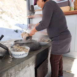 The Kim household's cook prepares to serve chicken stew.