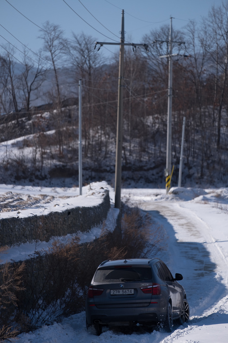 The car struggles in the snow on the road to the apple farm, shortly before being temporarily abandoned.