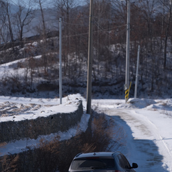 The car struggles in the snow on the road to the apple farm, shortly before being temporarily abandoned.