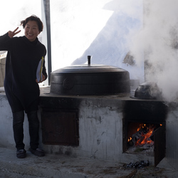 Kim Kyung-hee posing for a photo next to the outdoor oven.