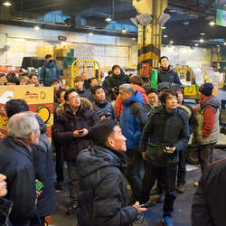 Bidders participate in a fruit auction in Garak market.