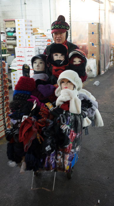 A mobile hat seller parades his wares inside the Garak market.