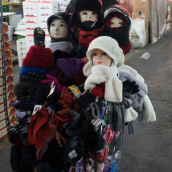 A mobile hat seller parades his wares inside the Garak market.