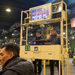 Auctioneers begin the sale of apples in the Garak market.